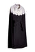 The Adèle Cape by Noémiah boasts a luxurious draped silhouette, showcasing a chic black and white wool design. It features a cape-like structure with the upper section in white, adorned with scalloped edges, and the lower section in black, echoing the refined scalloped details around the buttons. This elegant piece stands out beautifully against a neutral background.