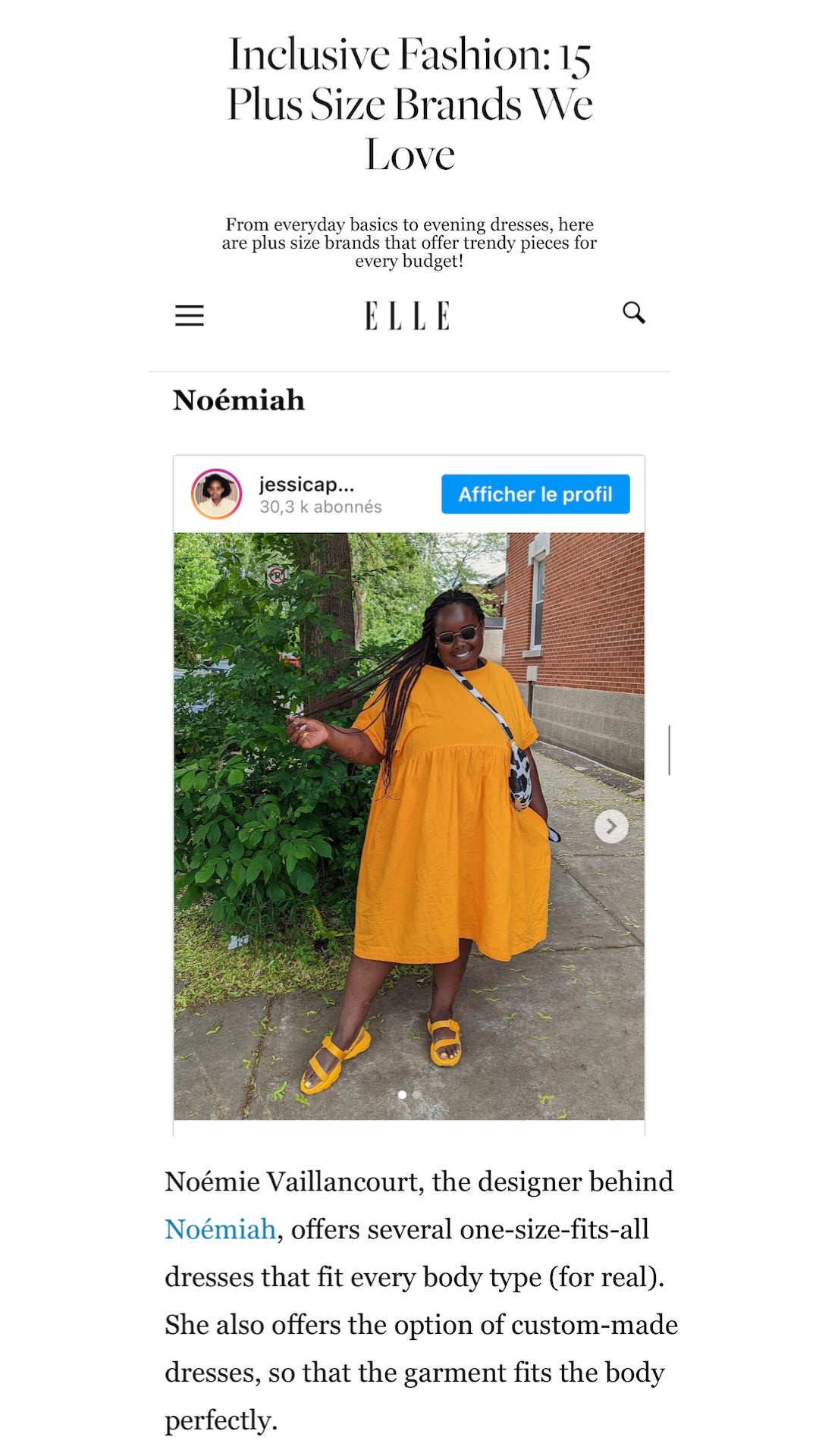 A person in a vibrant red Cécilia Classic Dress by Noémiah poses outdoors, surrounded by trees and greenery. They pair the dress with stylish yellow sandals and carry a small bag. Above them, text details an article on inclusive plus size fashion brands that embody relaxed femininity.