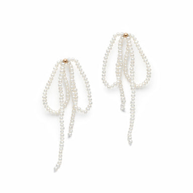 The elegant Lluvia Earrings by Noémiah feature multiple strands of freshwater pearls cascading gracefully. Each 14K stud is adorned with small pearls strung together, forming a delicate and sophisticated design with strands that slightly fan out at the bottom.