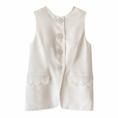 The Maxime Vest by Noémiah is a white sleeveless piece with a boxy fit, adorned with large porcelain buttons down the front and two decorative scalloped pockets.