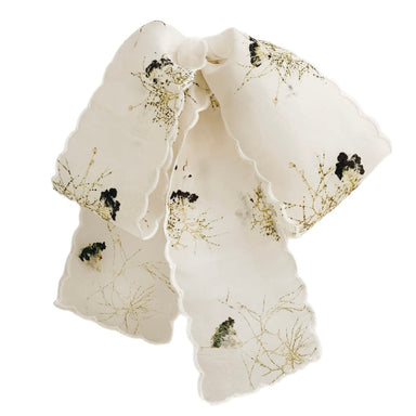 Introducing the Silk Barrette — Special Edition by Noémiah, a luxurious silk scarf adorned with intricate floral patterns inspired by Cotinus flowers in black and green against a white backdrop. This elegant accessory features a scalloped edge, adding an air of sophistication.