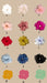 A collection of fifteen scrunchies made from Silk Ribbon by Noémiah in a variety of colors displayed on a beige background. Each scrunchie is labeled from A to O: white, light pink, light brown, peach, dark pink, bright pink, red, yellow, silver, light blue, dark blue, black, orange, and coral.