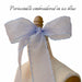 A sheer, periwinkle ice blue Silk Ribbon — Classic by Noémiah with scalloped embroidered edges is tied in a large bow on a dress form. Above, the text reads: “Periwinkle embroidered in ice blue.”.