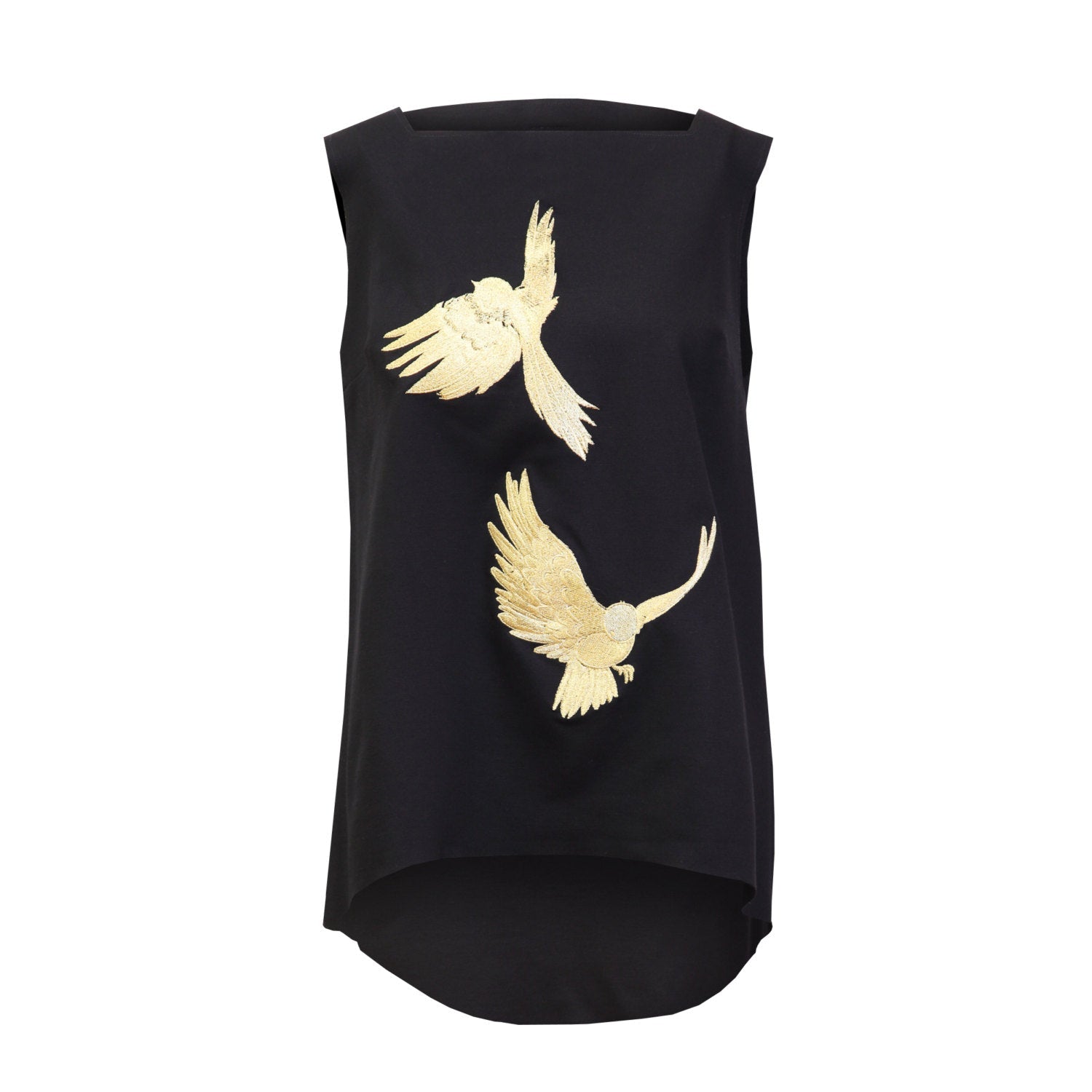 The Simone Top by Noémiah is a sleeveless black garment adorned with two gold embroidered birds in flight on the front. These stylized birds introduce a sense of movement against the dark fabric. The A-line design also includes a slightly elongated back hem for an added touch of flair.